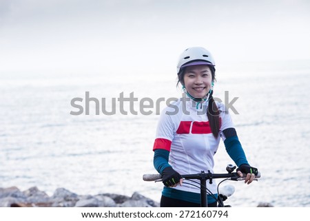 Cycling -Asian biker girl at seaside, woman fitness, healthy lifestyle