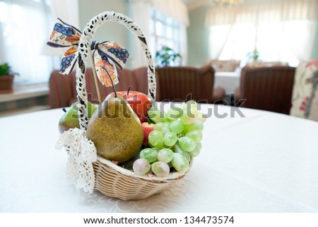 The sitting-room with basket of fruits on a table