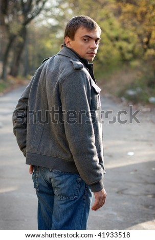 Portrait of a young man looking back