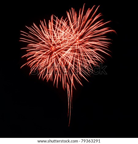 Bright red fireworks in the night sky in the form of heart