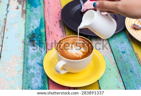Pour milk to Coffee cup,hot drink, tea milk,milk in jug