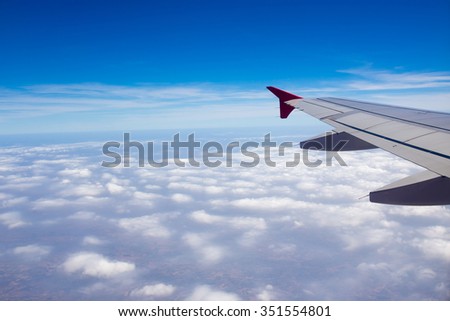 The wings of the plane, and the beautiful view from the glass window of the plane