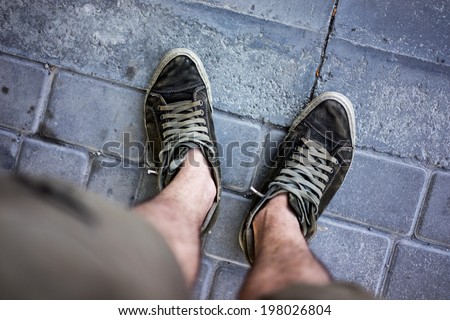 green sneakers on mans legs