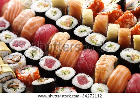 many tasty fresh japanese sushi with white rise red tuna caviar orange shrimp