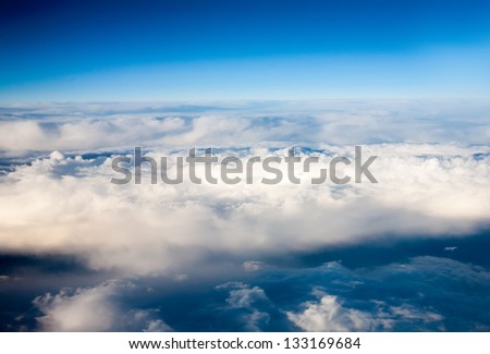 clouds. top view from the window of an airplane flying in the clouds. clouds like an ocean storm