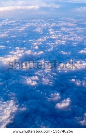clouds. top view from window of an airplane flying in clouds. at high altitude clouds are above you as well as for you