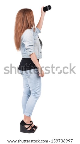 Back view of woman photographing. girl photographer in jeans. Rear view people collection.  backside view of person.  Isolated over white background.