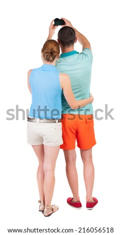 Back view of couple photographing. Tourists take pictures of the family together. Rear view people collection.  backside view of person. Isolated over white background.