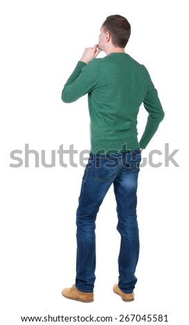 Back view of handsome man in blue pullover. Standing young guy in cardigan. Rear view people collection.  backside view of person.  Isolated over white background.