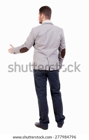 back view of businessman in jacket reaches out to shake hands. Rear view people collection. backside view of person.  A guy in a jacket with patches out his hand welcoming someone
