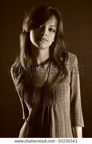 Sexual brunette fashion model  in knitted dress. Sepia.