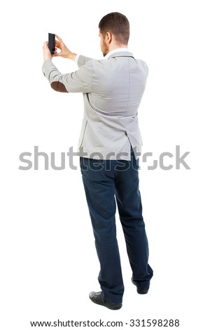 back view of business man on phone photographs. rear view people collection. Isolated over white background. backside view of person.  guy worth photographing everything around him.
