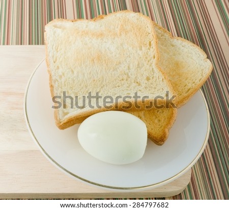 Cuisine and Food, Delicious Homemade Brown Toast with Boiled Eggs in A White Plate for Breakfast.