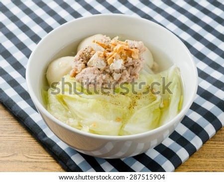 Thai Cuisine and Food, Bowl of Delicious Lettuce with Minced Pork and Fish Meat Ball Soup Topping with Fried Garlic.