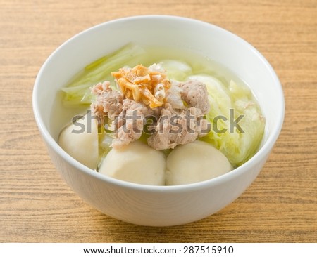 Thai Cuisine and Food, A Bowl of Lettuce with Minced Pork and Fish Meat Ball Soup Topping with Fried Garlic.