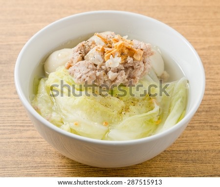 Thai Cuisine and Food, Bowl of Lettuce with Minced Pork and Fish Meat Ball Soup Topping with Fried Garlic.
