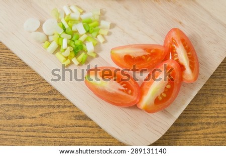 Vegetable, Sliced Grape Tomatoes or Cherry Tomatoes with Chopped Scallions on Wooden Cutting Board.