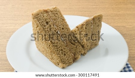 Snack and Dessert, Coffee Chiffon Cake Made With Butter, Eggs, Sugar, Flour, Baking Powder and Flavorings on White Dish.