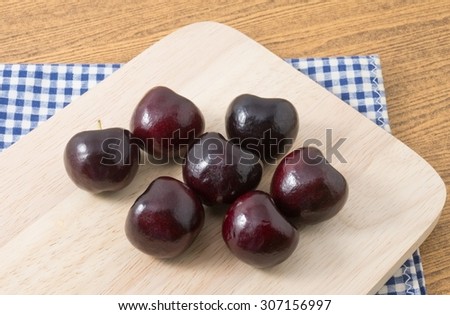Fresh Fruits, Ripe and Sweet Red Plums, A Very Good Source of Vitamin C on Wooden Cutting Board.