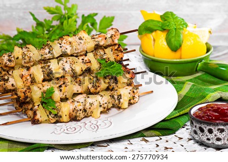Chicken skewers with herbs and pineapples. Grilling.