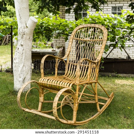 Wicker old wooden rocking chair in the garden