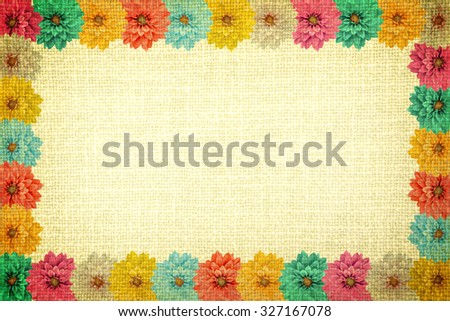 Vintage frame with dahlia flowers and old yellow cloth texture retro styled high contrasted with vignetting effect