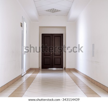 Kiev, Ukraine - July 6, 2015: White hallway with marble floor and brown door in hospital background