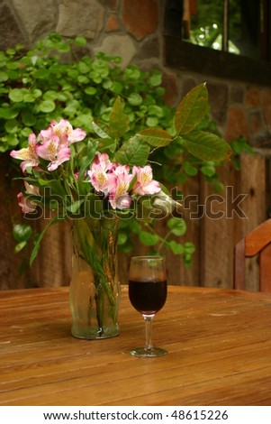 Wine and flowers on table