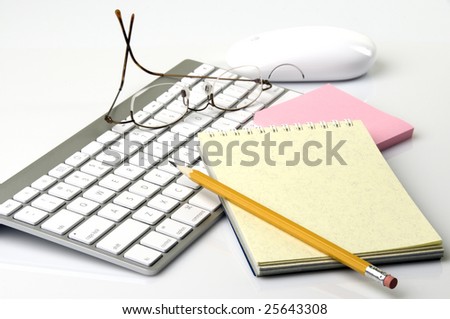 computer keyboard, mouse, notepads, pencil, and eyeglasses on white background