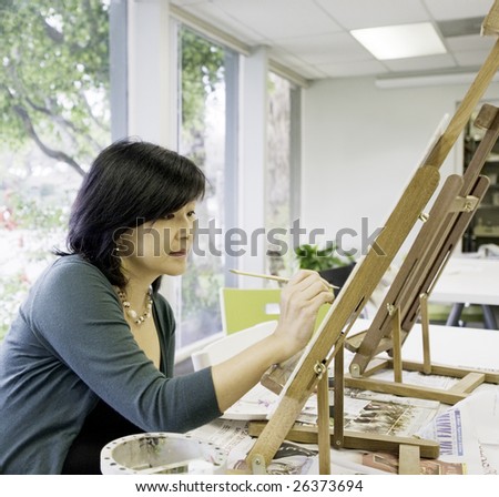 Art teacher paints in preparation for class