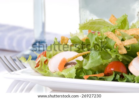 Salad Close-up with blue wine glass, sea green water glass and blue cloth