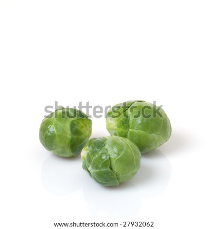 Three fresh, green brussels sprouts