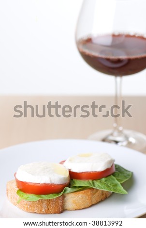Fresh basil, tomato, and mozarella cheese on french bread toasted, shallow depth of field with focus on left side of toast
