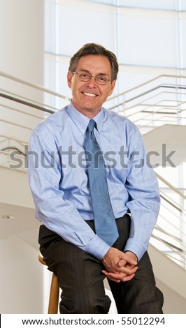 Middle age businessman sitting on stool