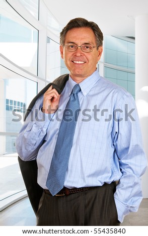Middle age businessman carrying a suit jacket on his way out of the office.
