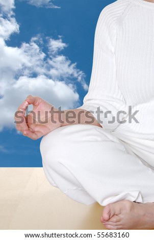 Mudra hand position during meditation with clouds and blue sky indicating the heavens