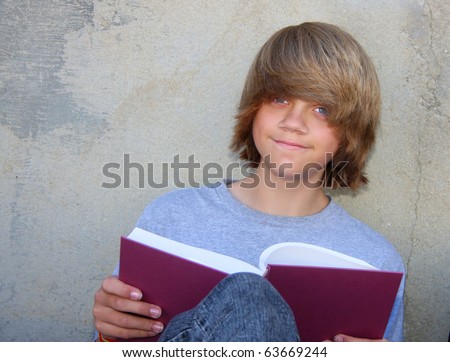 stock photo : Cute teen boy sitting against a cement wall reading a book. stock photo cute teen boy sitting against a cement wall reading a book 63669244 Hagerstown teen on America's Next Top Model show