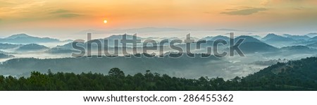 Sunrise over the panoramic mountains of Da Lat \
with his sun rise on the hill waxing pine soon covered with clouds and fog do to honor the beauty highland Da Lat