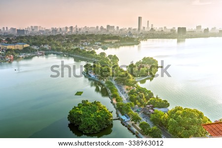 The road crossing the island West lake, Hanoi, Vietnam with green tree-lined streets, temples located between small oasis in sunshine of West Lake and boasts a beautiful evening in capital of Vietnam