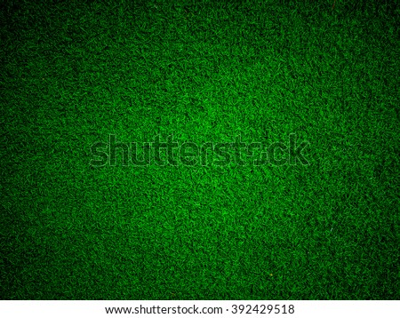 Abstract close up top view green color of artificial grass background texture made width dark border filters.