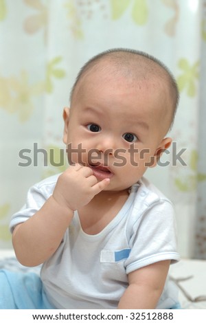 it is a cute chinese baby, isolated. he is 6 months.