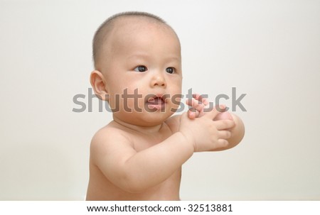 it is a cute chinese baby, isolated. he is 6 months.