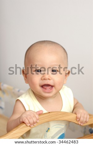 it is a cute chinese baby, he is 7 months, and has 2 little teeth.