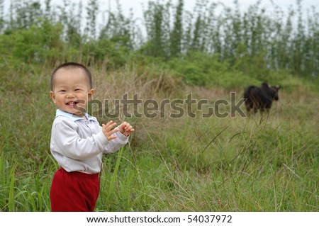 it is a laughing chinese baby on outdoor.