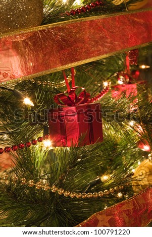 close up of Christmas present shape tree decoration on a illuminated Christmas tree