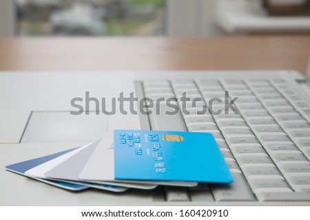 A Group Off Credit Cards And Bank Cards On A Mobile Computer Laptop Keyboard