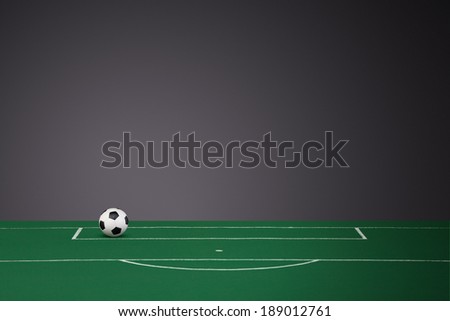 Black & White Leather Football on a fabric football pitch