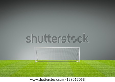 football concept showing empty football pitch and football goal posts with goal net and space for text