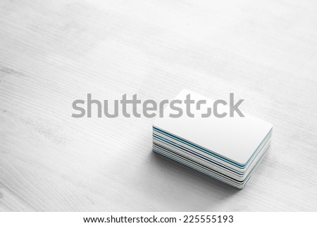 blank white bank card & pile of Credit cards and Bank Cards on white wood