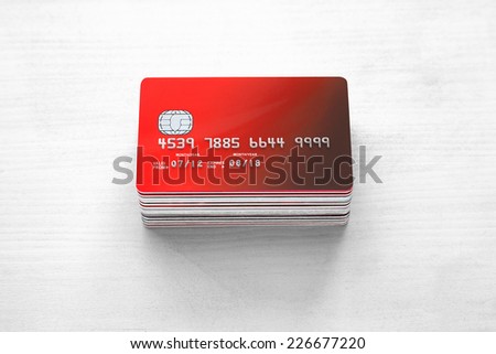 pile of Credit cards and Bank Cards on white wood
